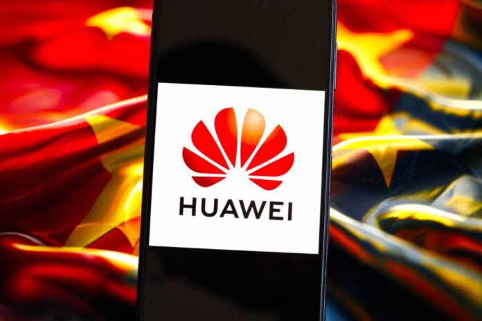 Huawei,Company,Logo,On,Screen,Of,Smartphone,Against,Blurred,Background