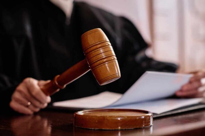 Wooden,Gavel,Held,By,Experienced,Female,Judge,Over,Sounding,Block