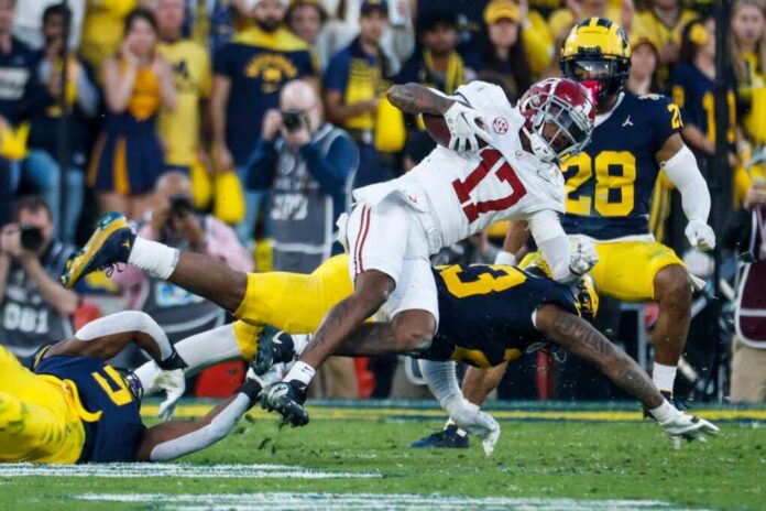 Alabama,Wide,Receiver,Isaiah,Bond,(r)is,Tackled,By,Michigan,Edge