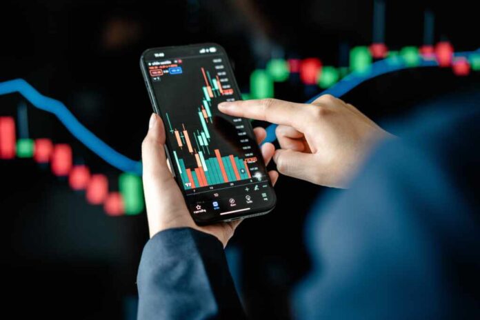 Investors,Analyze,The,Data,Stock,Market,Index,Via,Smartphone,Screen