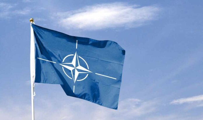 Nato,Flag,On,Cloudy,Sky.,Flying,In,The,Sky