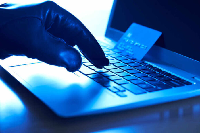 Cyber,Criminal,With,Stolen,Credit,Card,And,Laptop