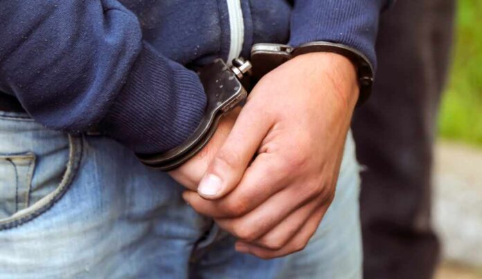 A,Police,Officer,Arrests,A,Drug,Dealer.,Weapons,,Handcuffs,Close-up.