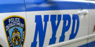 Close-up of a New York Police Department vehicle with badge and NYPD lettering