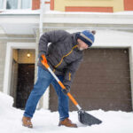 Blizzard Alert: NYC’s Shocking ID Demand Senior man shoveling snow in front of a house