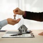 Mortgage Rate Plunge Stuns Homeowners A person handing over house keys during a real estate transaction