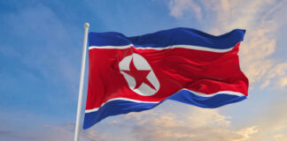 North Korean flag waving against a blue sky
