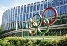IOC’s Controversial Policy Stuns Inclusion Advocates Colorful Olympic rings displayed in front of a modern building