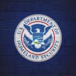 Logo of the U.S. Department of Homeland Security on a blue wall