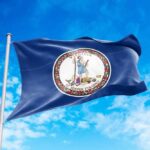 Government-Mandated History Sparks Outrage Virginia state flag waving against a blue sky