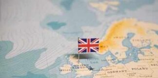 A map of Europe with a small flag of the United Kingdom pinned on it