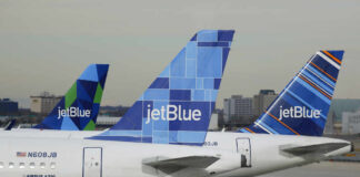 Three jetBlue aircraft tails lined up at an airport