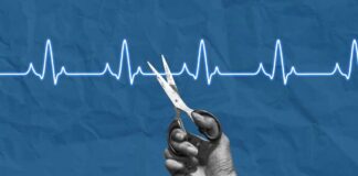 A hand holding scissors above a heartbeat line on a blue background