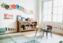 A bright and colorful children's room with a bookshelf and a play table