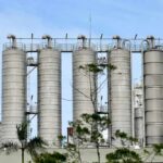 Inflation Alarm: Energy Costs Roar Back Metal storage silos against a blue sky