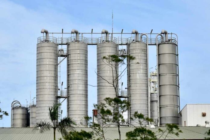 Metal storage silos against a blue sky