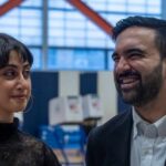 Two individuals engaged in conversation at a voting location