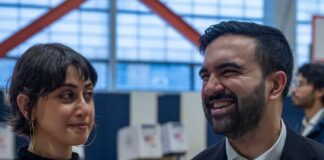 Two individuals engaged in conversation at a voting location