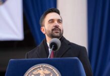 Man speaking at a podium during a formal event