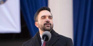 Man speaking at a podium during a formal event