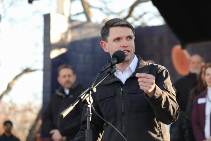 shutterstock_2734324469.jpg Individual speaking into a microphone at an outdoor event