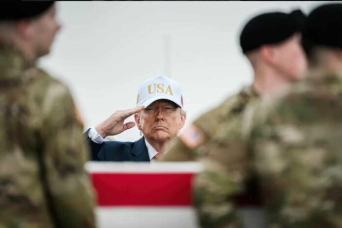 A man in a USA cap saluting in front of soldiers