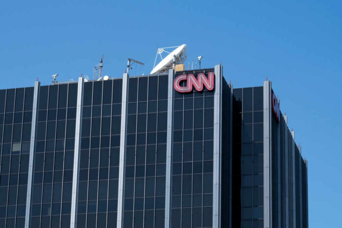 shutterstock1960282819jpg The top of the CNN building featuring the logo and broadcasting equipment against a clear blue sky