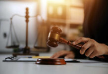 A gavel being struck on a desk in a courtroom setting