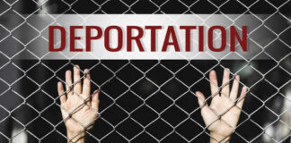Shock Plan: 1 Million Deportations – Is It Possible? Hands reaching through a metal fence with the word DEPORTATION above