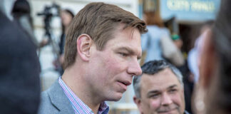 FBI Chief Weighs Explosive Spy File Release Two men engaged in conversation at an outdoor event