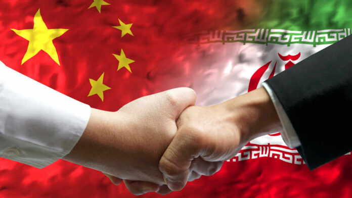 Handshake between two individuals with Chinese and Iranian flags in the background