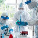Scientists in protective suits conducting research in a laboratory