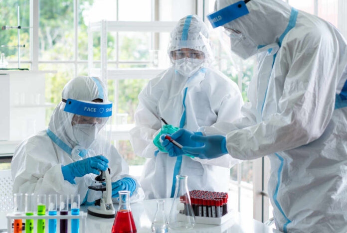 Scientists in protective suits conducting research in a laboratory
