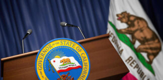 Podium with the seal of the Governor of California and state flag in the background