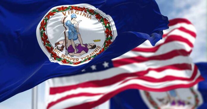 shutterstock_2168133913.jpg Virginia state flag waving in the foreground with an American flag in the background