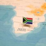 Africa Splitting FASTER — Scientists Stunned by Discovery A small South African flag placed on a map of Africa