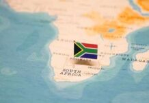 A small South African flag placed on a map of Africa