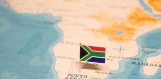 A small South African flag placed on a map of Africa