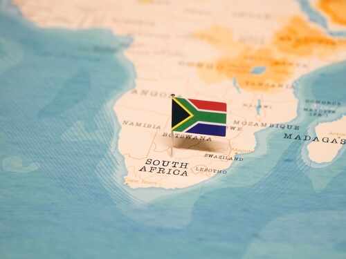 A small South African flag placed on a map of Africa