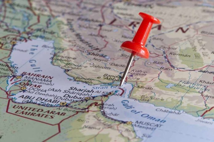 shutterstock_2449365203.jpg A red pushpin on a map of the Middle East highlighting a specific location
