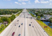 Aerial view of a busy highway with multiple lanes and vehicles