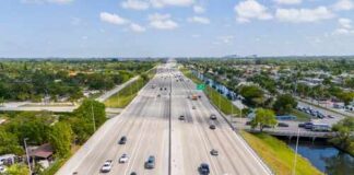 Aerial view of a busy highway with multiple lanes and vehicles
