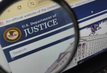 Close-up view of the U.S. Department of Justice website through a magnifying glass