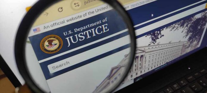 Close-up view of the U.S. Department of Justice website through a magnifying glass