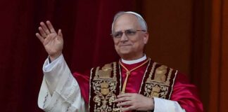 Pope’s Peace Message: Empty Words or Real Change? A religious leader in papal attire waving from a balcony
