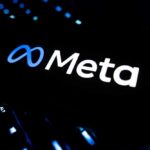Big Tech’s Ruthless Job Cuts for AI Dominance Illuminated Meta logo against a dark background