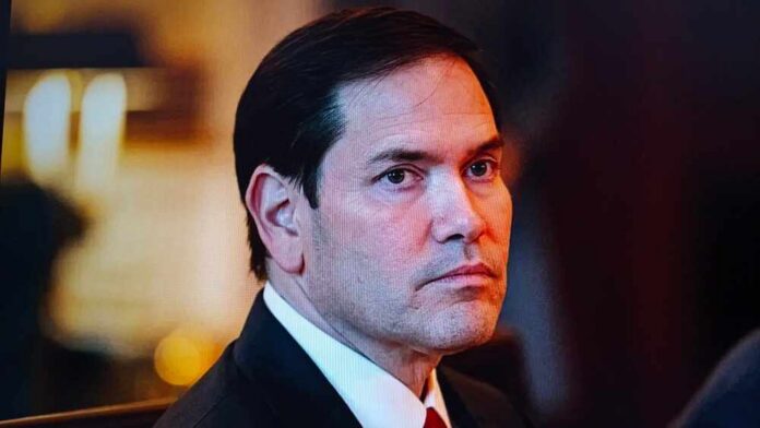 A serious-looking man in formal attire with a focused gaze