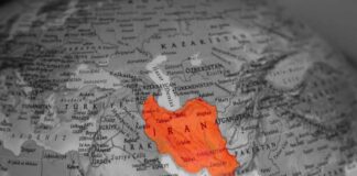 Map highlighting Iran in orange on a grayscale background