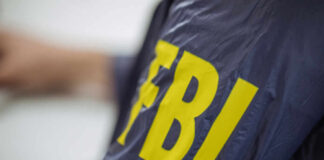 FBI ALERT: Foreign Exploitation of US Labs Close-up of an FBI agents jacket with yellow lettering
