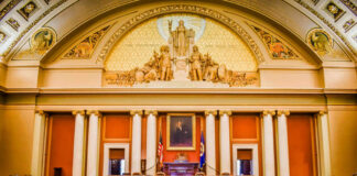 Massive Fund Mystery: $1.7B in Shadows! Interior view of a legislative chamber with wooden furniture and decorative ceiling